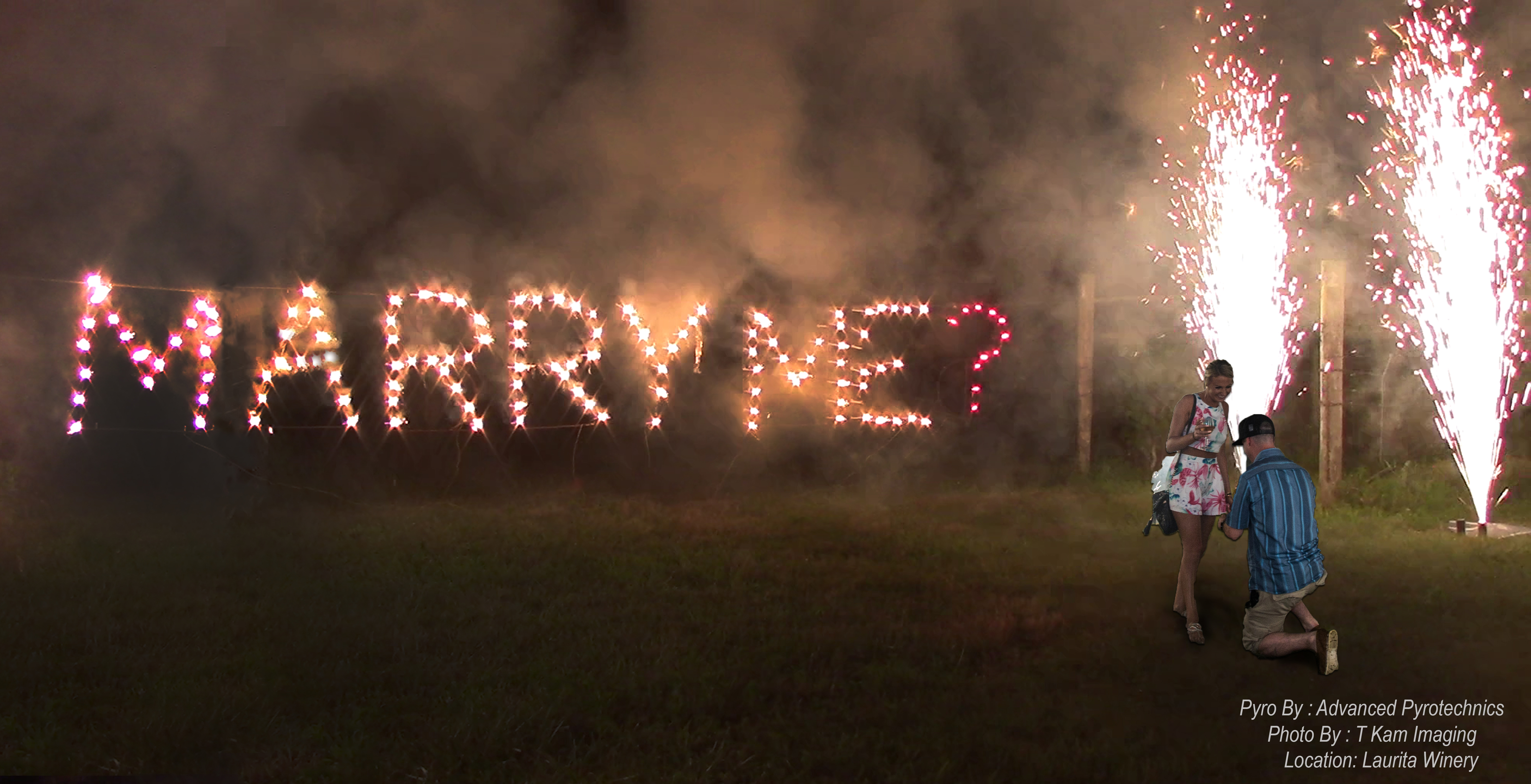 A wedding proposal featuring the couple and a fire writing set piece that says Marry Me? that was designed by Advanced Pyrotechnics, a fireworks company.