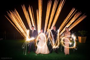 A wedding party spells out Love with sparklers as a PA wedding fireworks show takes place.